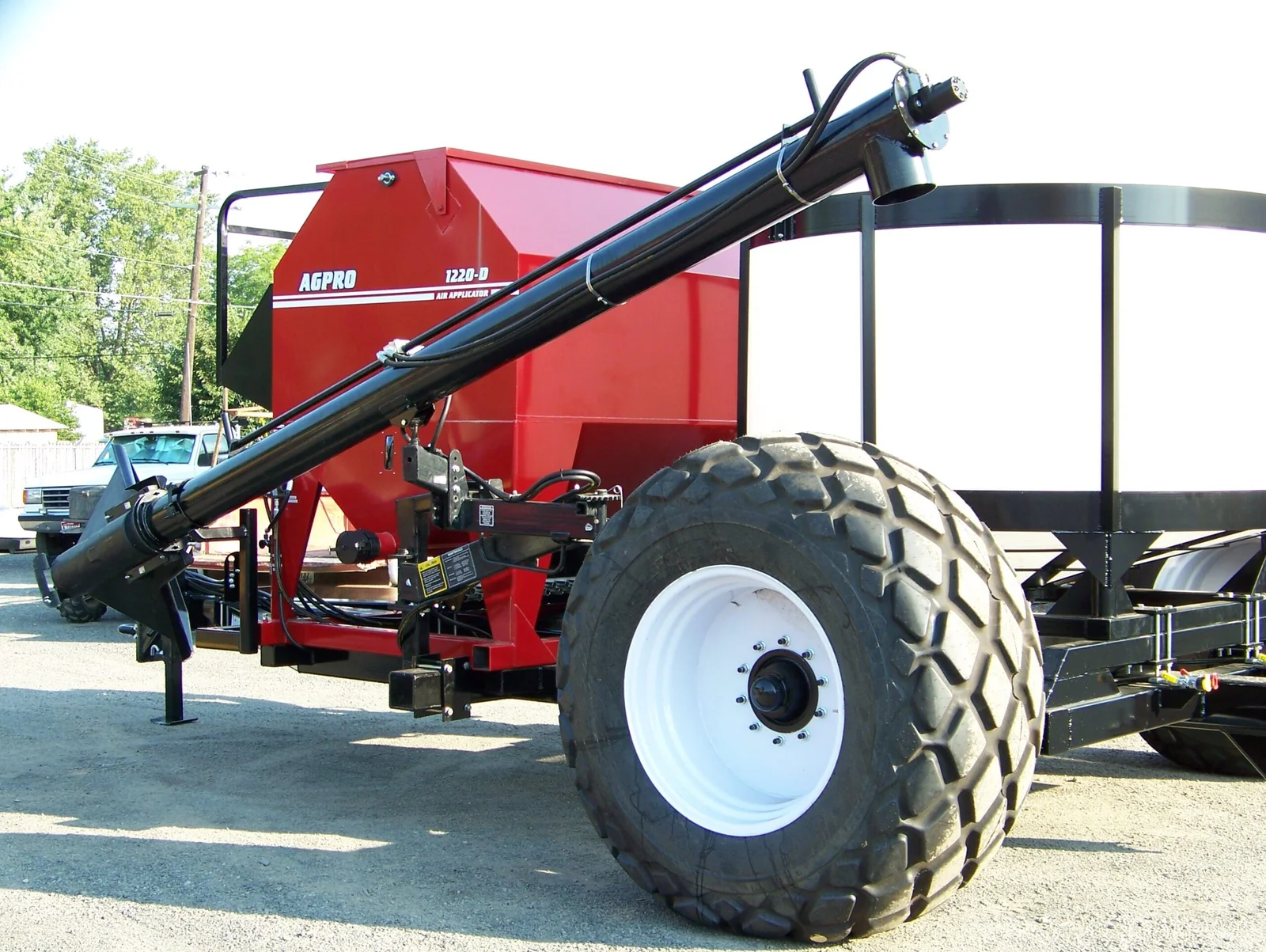 Custom commodity cart | AGPRO Red AGPRO commodity cart with an air applicator, loading auger, and white liquid tank